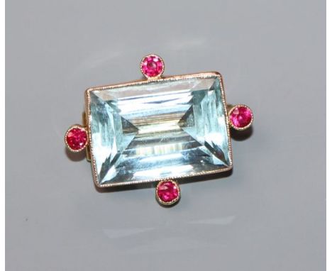A 15ct, synthetic? ruby and aquamarine set brooch, 25mm.