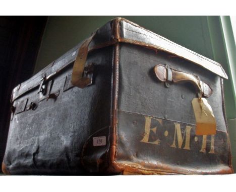 A large leather travelling trunk, bearing the initials E M H.