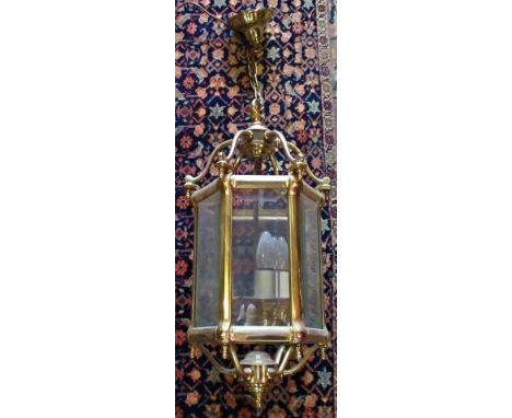 A 20th century brass hanging lantern, having, six bevel glazed panels and three branch light fitting.