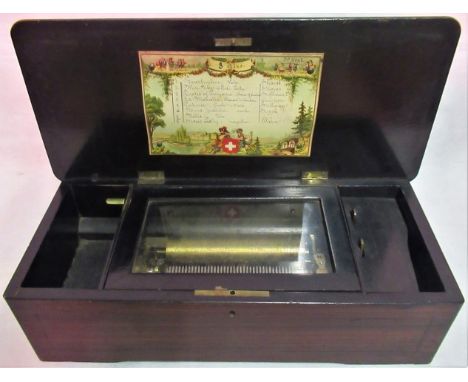 A 19th century simulated rosewood and walnut cased cylinder music box, playing eight airs. Condition Report: Music box in wor
