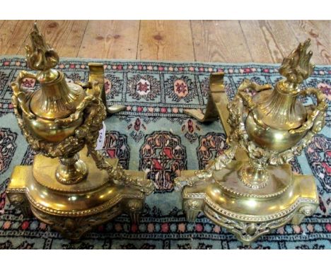 A pair of Regency-style brass fire dogs. Condition Report: Light impact dents to each inner side of bases.  Other minor scrat