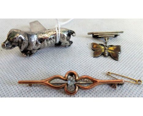 An Edwardian single knife rest modelled as a dachshund, London 1904, a silver and enamel butterfly brooch and a 9ct gold bar 