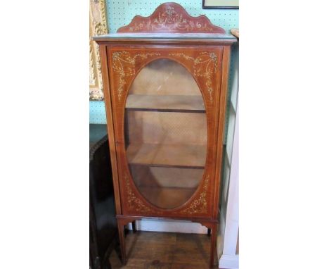 An Edwardian mahogany china cabinet, with flower and ribbon decoration, oval glazed panel door on square tapering supports.