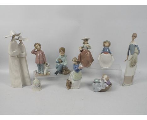 A collection of Spanish porcelain figures / groups by Lladro and Nao and a Lladro bell, largest approximately 32 cm (h).