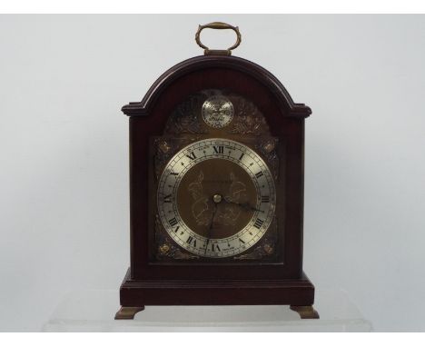 A Garrard mahogany cased mantel clock with Roman numerals to a silvered chapter ring and Tempus Fugit roundel, approximately 