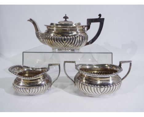 A late Victorian, three piece, silver tea service with gadrooned decoration, Chester assay 1898 / 1899, sponsors mark for Wil