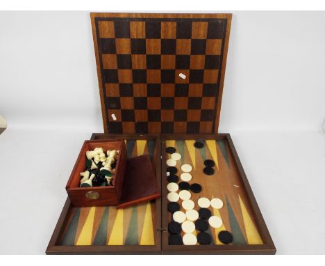 A chess set and board, king approximately 9 cm (h) and a folding backgammon board. [3]