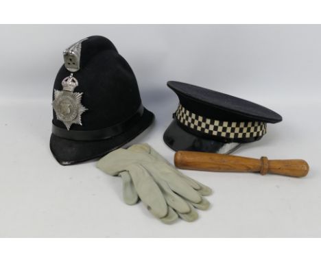 A vintage Warrington Borough Police helmet, a vintage wooden truncheon and a vintage police cap and gloves.