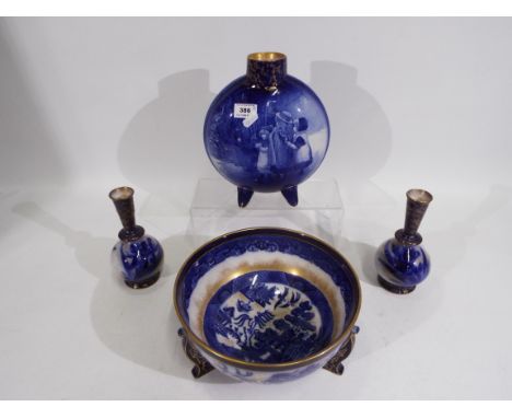 Doulton Burslem - Four pieces comprising a Willow pattern bowl raised on tripod supports, 24 cm (d), a Blue Children moon fla