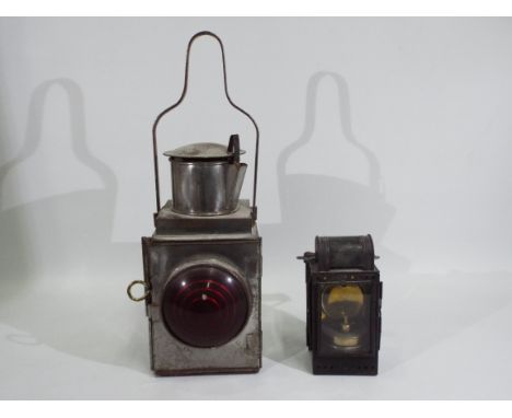 A German railway lantern inscribed with maker Wilhelm Kohler, Gorlitz, 24 cm (h) including handle and a further lantern. [2]