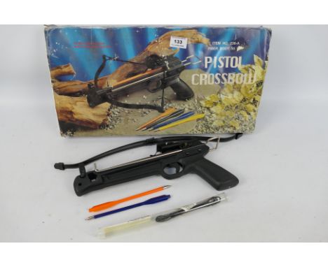 A boxed pistol crossbow with two plastic steel tipped bolts.