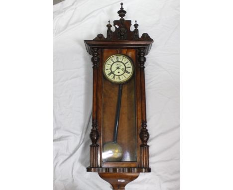 A Vienna style wall clock, walnut case with turned and applied decoration, glazed door, surmounted by decorative carved pedim