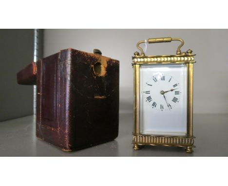 An early 20th century French, brass cased carriage clock, five windows, white enamel Roman dial, in original leather case wit