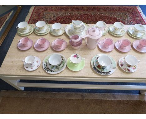 A Noritake part teaset together with mixed tea cups and saucers and a pink part coffee set