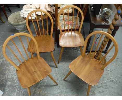 A set of four Ercol beech and elm hoop back Windsor chairs, on turned legs
