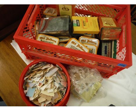 A stamp collection comprising vintage tins containing loose stamps
