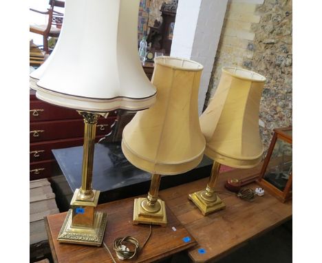 A pair of modern brass table lamps, another similar and a modern Chinese porcelain lamp