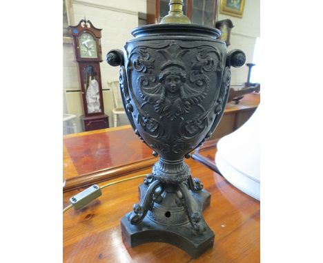 A Victorian case metal oil lamp on black a marble base, later converted to electricity, with fabric shade