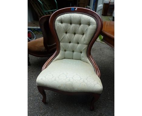 A mid 20th century Victorian style spoon back chair having a mint coloured, button upholstered back and seat