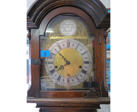 A 1930s oak cased grandmother clock with a visible pendulum, a bras face and silvered chapter ring, 5'8 high A/F