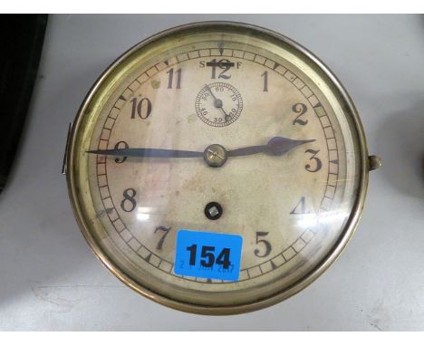 A brass ships bulk-head clock having a silvered dial and off set seconds