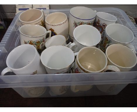 A large selection of commemorative porcelain mugs, cups and saucers, drinking glasses to include a Wedgwood cut glass goblet 