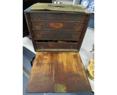 A small oak tool chest having four graduated drawers with mixed tools