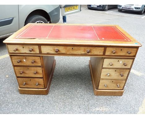 A Victorian mahogany twin pedestal desk, circa 1890 with later inset leather scriber, turned button bun handles on plinth bas