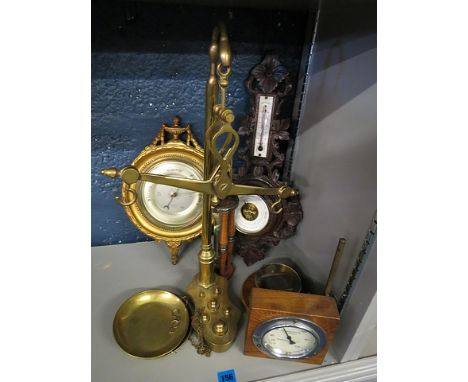An early 20th century car clock on a mahogany stand, thermometer and two barometers