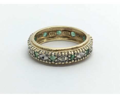 A 9carat gold eternity ring set with small diamonds ring size I.