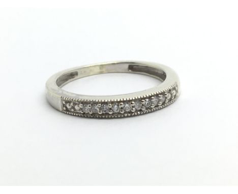 An unmarked white metal half eternity ring, approx 1.4g and approx size H.