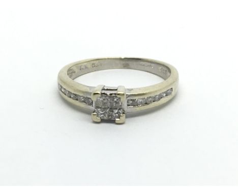 A 9carat gold ring set with a princess pattern of diamonds the shank with further diamonds. ring size L.