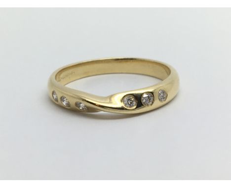 An 18ct gold ring set with six small diamonds, approx 3g and approx size N.