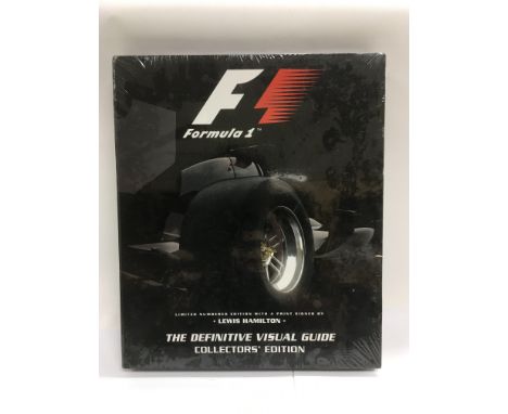 A sealed 'Formula One - The Definitive Visual Guide' hardback book with a ltd edition print signed by Lewis Hamilton.