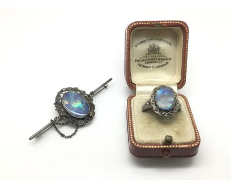 A silver opal ring and a similar opal brooch (2).