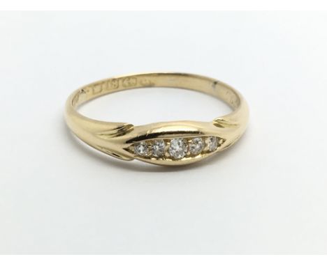 An 18carat gold ring set with a row of five small diamonds ring size Q-R