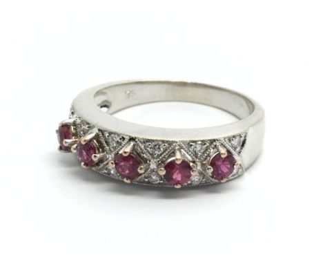 A decorative 18 carat white gold ring set with five ruby and diamond ring. Ring size N-O