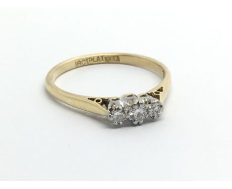 An 18carat gold ring set with three diamonds ring size N.