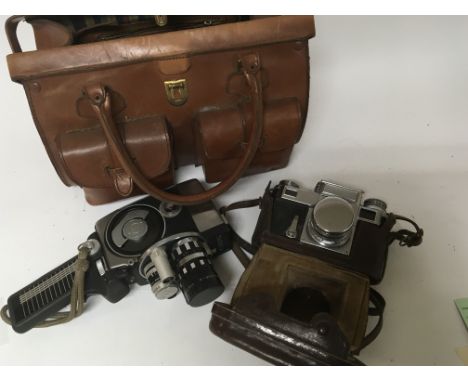 A Vintage leather camera bag a Zeiss Ikon camera Contax and Yashica cine camera