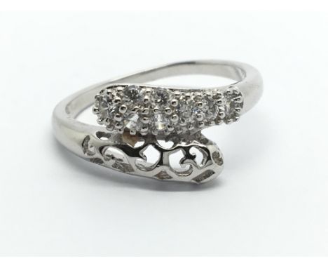 A white gold ring in the form of snakes heads set with small diamonds. ring size N.