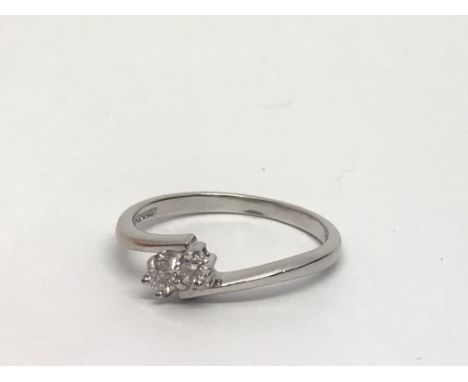 An 18ct white gold two stone diamond ring, approx .15ct, approx 2.6g and approx size L-M.