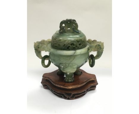 A carved jade incense burner raised on a hardwood stand, total approx height 17cm.