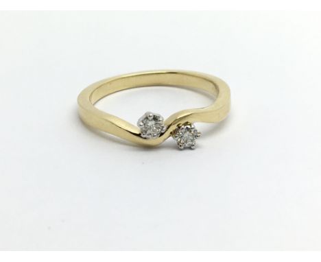 An 18ct gold two stone diamond ring, approx.20ct, approx 3.4g and approx size M.