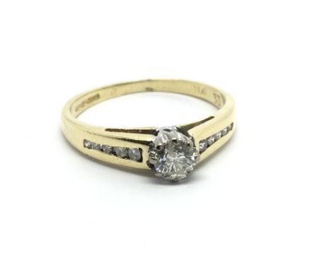 An 18carat gold ring set with a solitaire brilliant cut diamond the shank with further diamonds ring size J-K