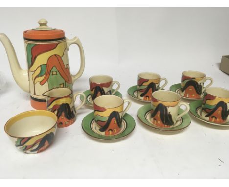 A rare Clarice Cliff Bizarre Cottage pattern coffee set decorated with the black and orange cottage with a simulated orange a