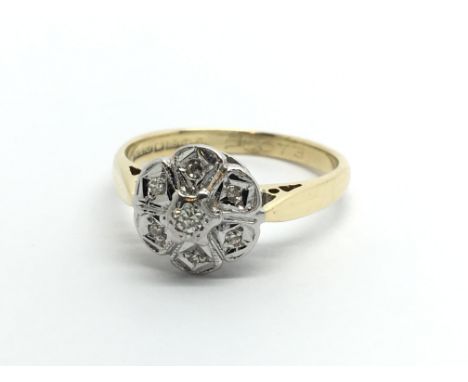 An 18ct gold seven stone diamond ring in a flowerhead setting, approx 2.8g and approx size J-K.