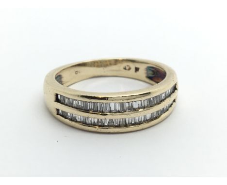 A 9ct gold ring set with two rows of baguette cut diamonds, approx 3.9g and approx size L.