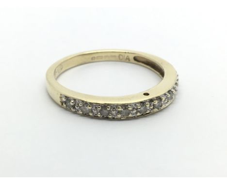 A 9carat gold ring. A half hoop eternity ring set with a single row of small diamonds. ring size N.