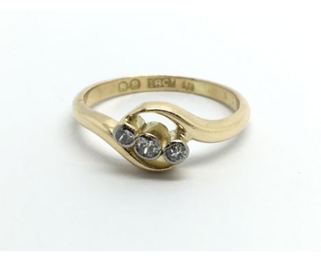 An 18ct gold three stone ten point diamond ring, approx 2.6g and approx size K-L.