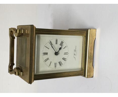 A brass cased carriage clock maker JW Benson London with key and seen working.